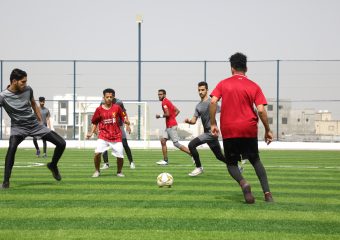 STUDENTS PLAYING FOOTBALL AT BAYAN COLLEGE FOOTBALL STADIUM